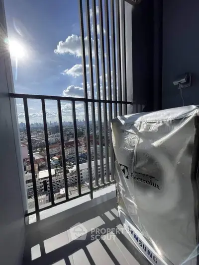 Stunning city view from a high-rise balcony with modern appliances.