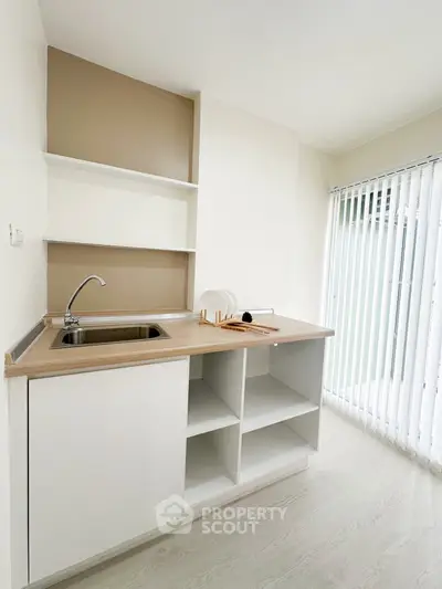 Modern minimalist kitchen with open shelving and sleek design