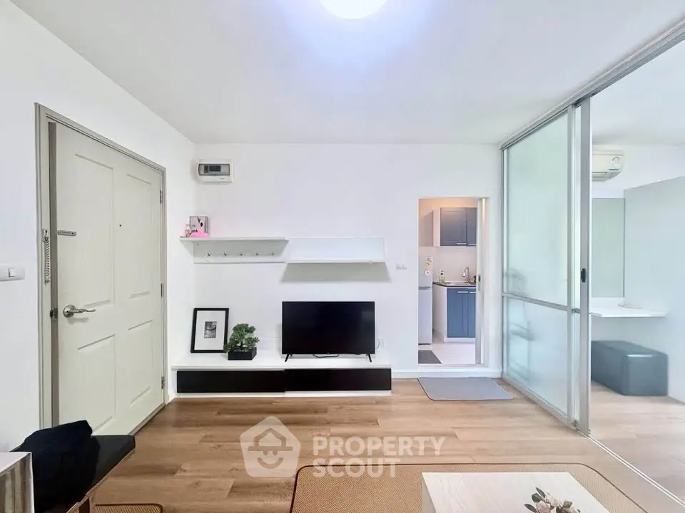 Modern living room with sleek design and open layout, featuring a TV unit and stylish decor.