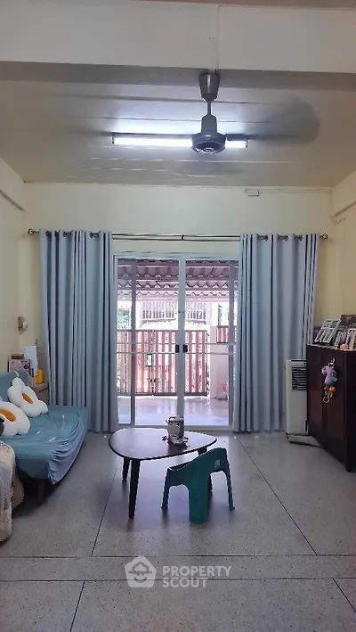 Cozy living room with balcony access and natural light