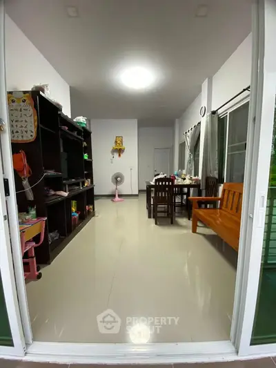 Spacious living room with modern furniture and large windows for natural light.