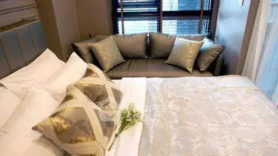 Luxurious bedroom with elegant decor and cozy seating area