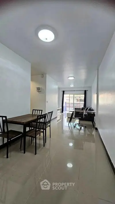 Spacious open-plan living and dining area with modern furnishings and natural light.