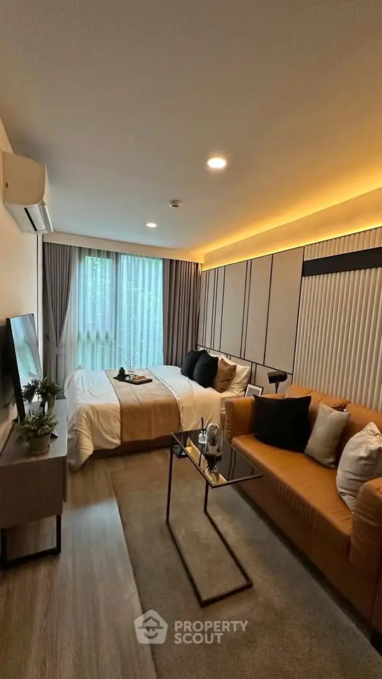 Modern bedroom with cozy seating area and stylish decor