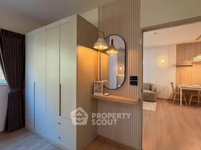 Modern apartment interior with stylish lighting and wooden flooring, featuring a cozy living area and elegant decor.