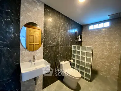 Modern bathroom with elegant marble walls and sleek fixtures