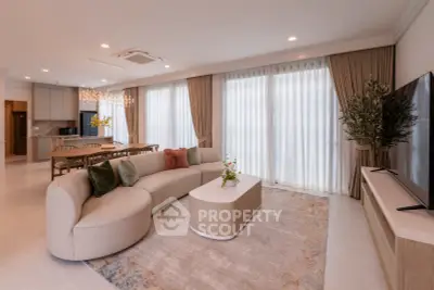 Luxurious living room with elegant decor, large windows, and modern furniture in a spacious open layout.