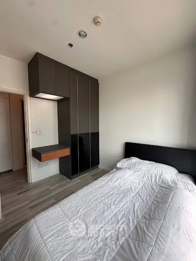 Modern bedroom with sleek wardrobe and cozy bed in minimalist design.