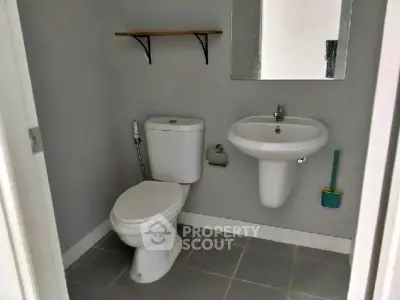 Compact bathroom with modern fixtures and neutral tones