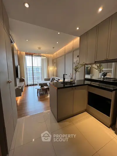 Modern open-layout living room with stylish kitchen and elegant decor