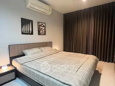 Modern bedroom with stylish decor and air conditioning in a cozy apartment.