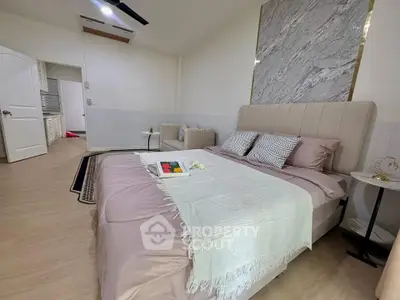 Luxurious bedroom with elegant decor and plush bedding in a modern home.