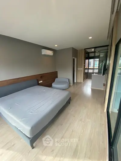 Spacious modern bedroom with sleek design and large windows