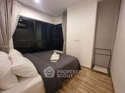 Cozy modern bedroom with large window and stylish decor