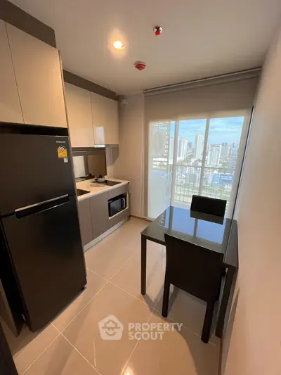 Modern kitchen with sleek appliances and city view from balcony