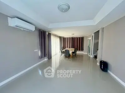Spacious modern living room with dining area and large windows