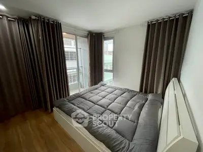 Cozy bedroom with large windows and modern decor in urban apartment