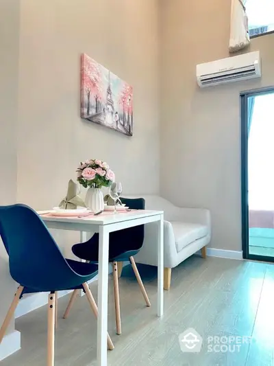 Modern dining area with elegant decor and natural light in a cozy apartment.