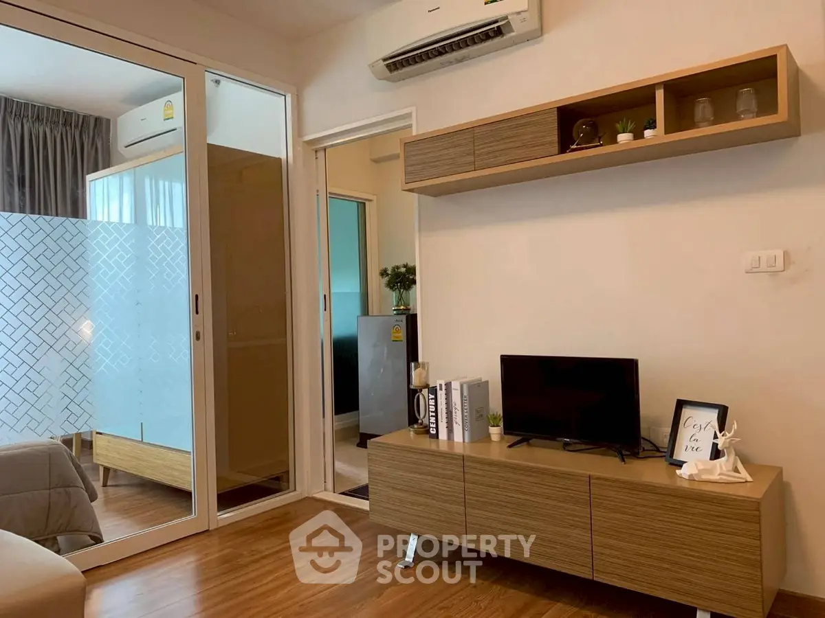 Modern living room with sleek wooden furniture and air conditioning