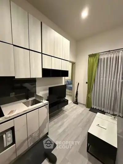 Modern kitchen with sleek cabinetry and open layout in stylish apartment