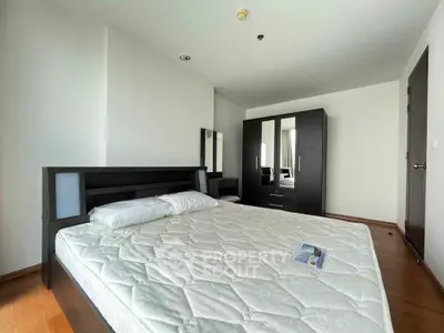 Spacious bedroom with modern furniture and natural light