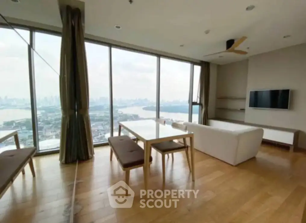 Spacious living room with panoramic city view and modern furnishings