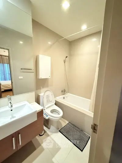 Modern bathroom with bathtub and sleek fixtures in a contemporary apartment.