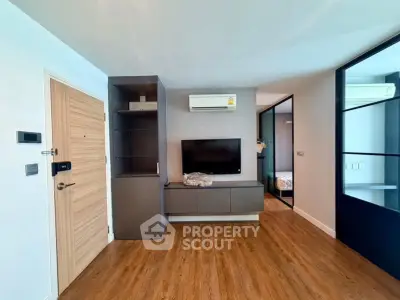 Modern living room with wooden flooring and sleek TV setup