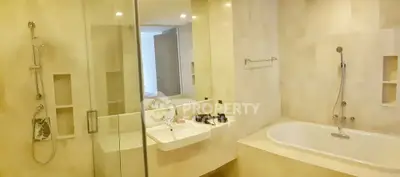Luxurious bathroom with modern fixtures and spacious bathtub in elegant real estate property.