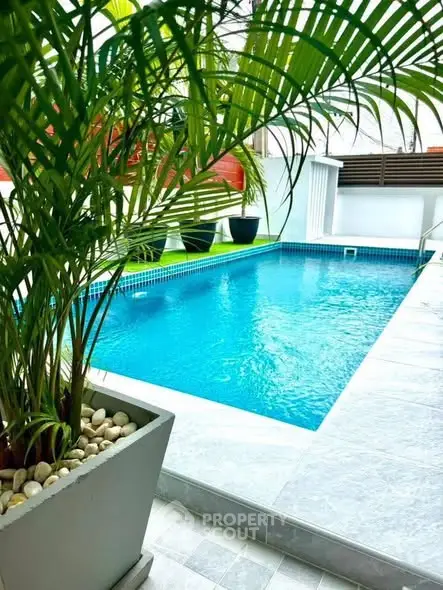 Luxurious private pool with lush greenery and modern design