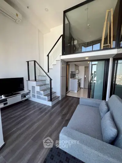 Modern loft apartment with mezzanine, sleek staircase, and stylish living area.