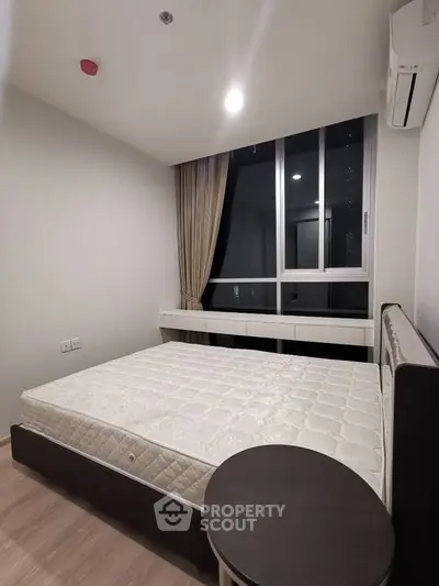 Modern bedroom with large window and air conditioning unit