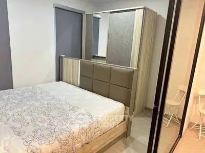 Cozy bedroom with modern furniture and ample storage space in a stylish apartment.