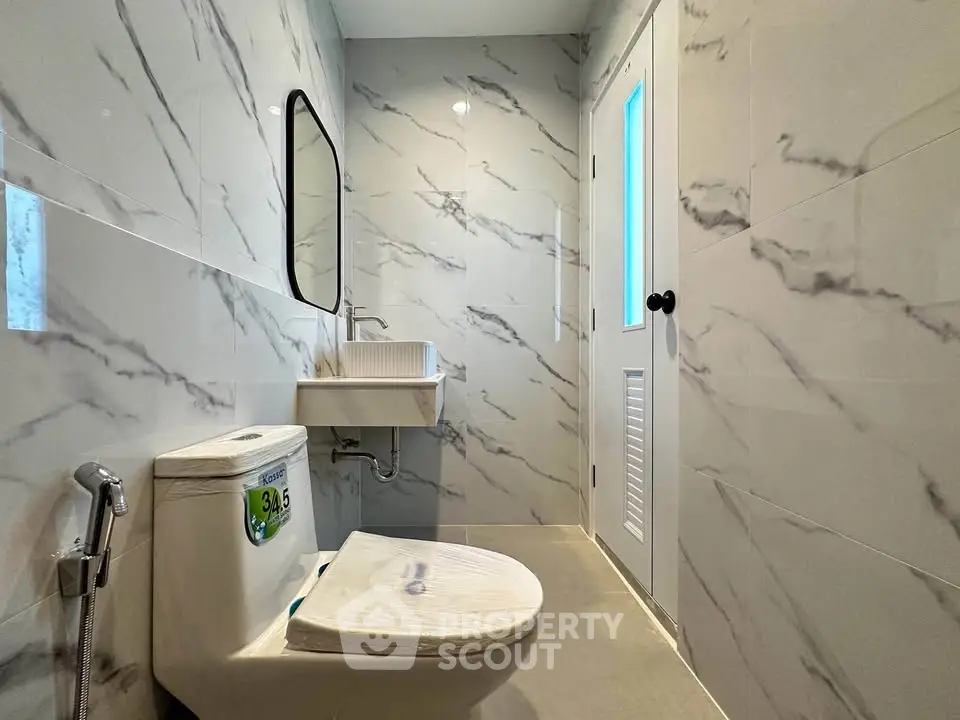 Modern bathroom with marble walls and sleek fixtures