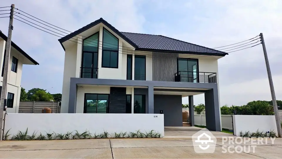 Modern two-story house with sleek design and spacious driveway in a serene neighborhood.