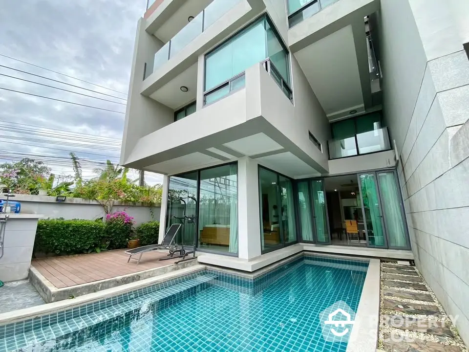 Modern multi-story home with private pool and glass facade