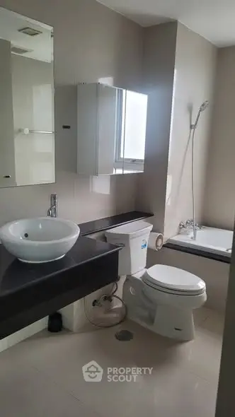Modern bathroom with sleek fixtures and bathtub in a contemporary home.