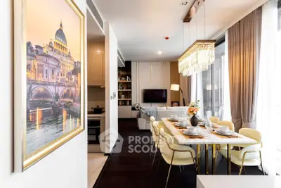 Luxurious open-plan living and dining area with elegant decor and modern lighting.