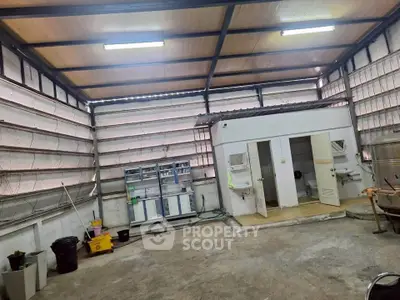 Spacious industrial-style storage unit with high ceilings and ample lighting.