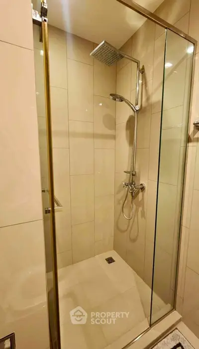 Modern bathroom with glass shower enclosure and rainfall showerhead