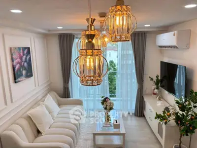 Elegant living room with modern lighting, plush sofa, and large window view.