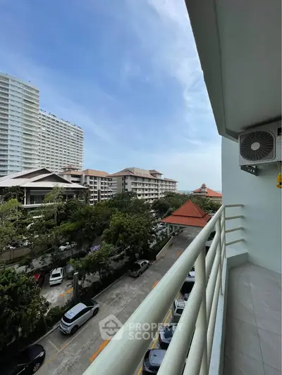 Spacious balcony with city view and modern buildings, perfect for urban living.
