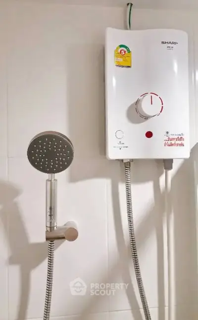 Modern bathroom with sleek showerhead and efficient water heater for a comfortable living experience.