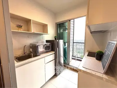 Modern kitchen with balcony view, featuring sleek appliances and open shelving, perfect for urban living.