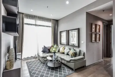 Modern living room with stylish decor and large windows in a contemporary apartment.