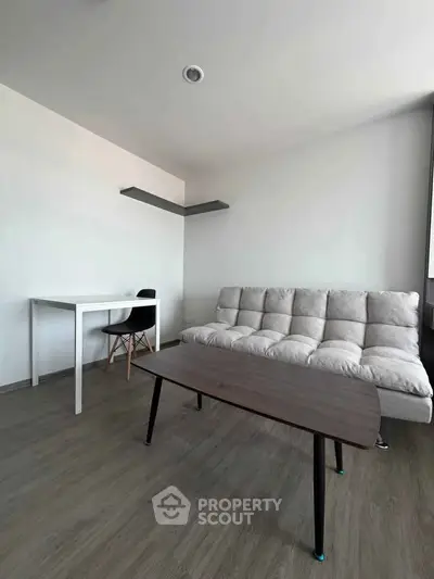 Modern minimalist living room with sleek furniture and wooden flooring