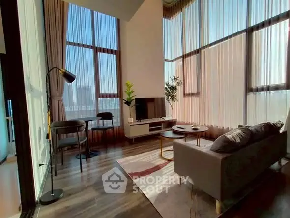 Luxurious high-ceiling living room with modern decor and large windows offering stunning city views.