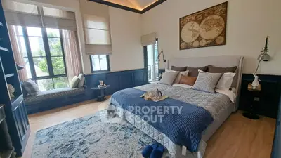 Luxurious bedroom with elegant decor and large windows offering natural light and serene views.