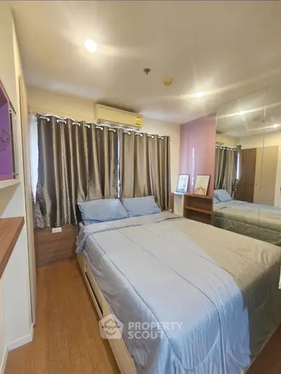 Cozy bedroom with modern decor and ample natural light