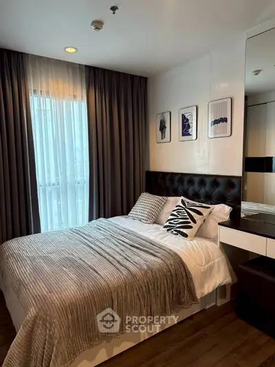 Modern bedroom with stylish decor and natural light in a cozy apartment.
